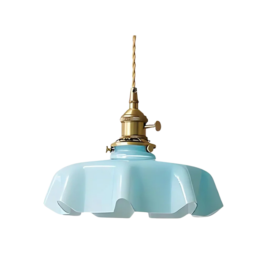 Blue scalloped glass shade with a brass top on a plain white background