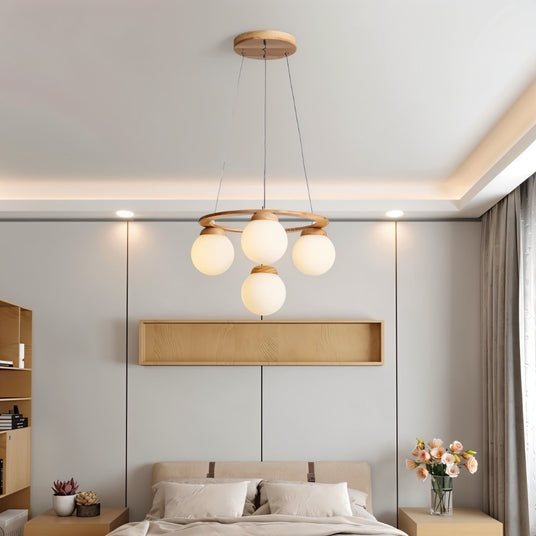 The ring lit above a bed with a wood panel niche on the wall behind it