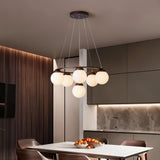 The ring lit over a kitchen dining table with chairs and a fluted wood wall