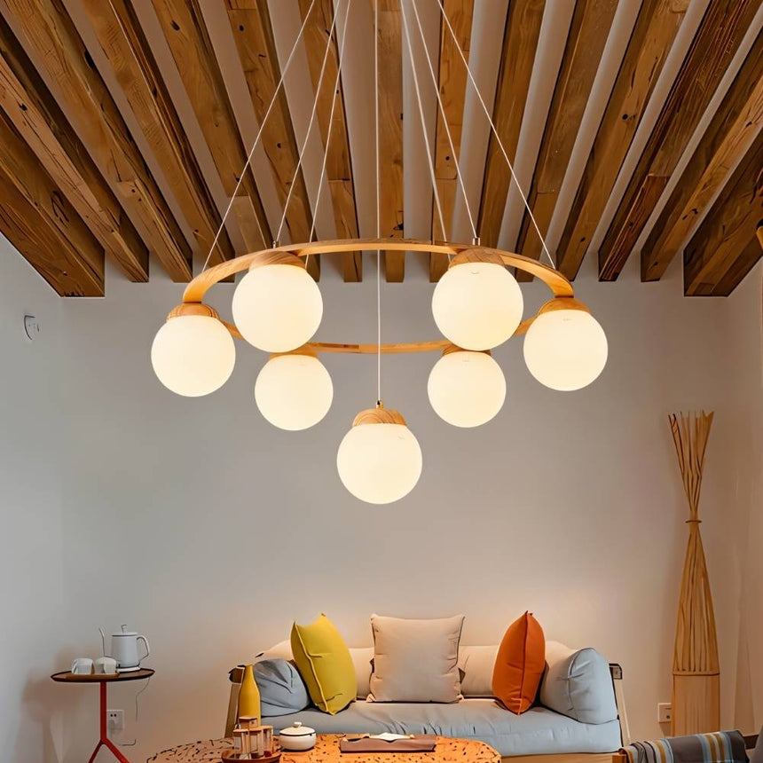 The ring lit in a living room with a sofa, cushions and exposed wood ceiling beams