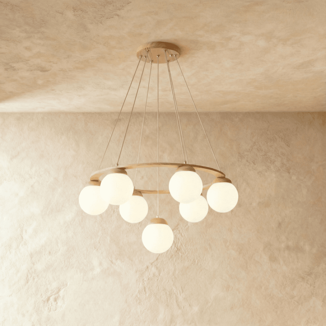 A pale wood ring carrying white glass globes at two heights on thin cables