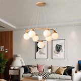The ring lit in a living room above a sofa with two framed prints on the wall
