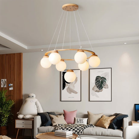 The ring lit in a living room above a sofa with two framed prints on the wall