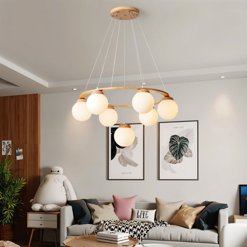 The ring lit in a living room above a sofa with two framed prints on the wall