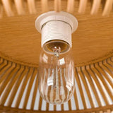 Close view of the socket inside the slatted wood shade