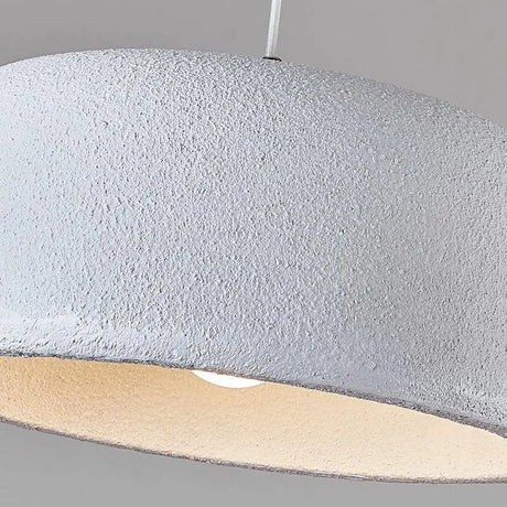 Wide textured dome seen close, the matte surface catching a low light