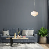 Opal shade lit above a gray sofa with cushions and a low table