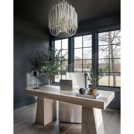 The fitting lit above a wood console table against a dark wall