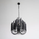 The black version of the rod chandelier seen against a plain ground