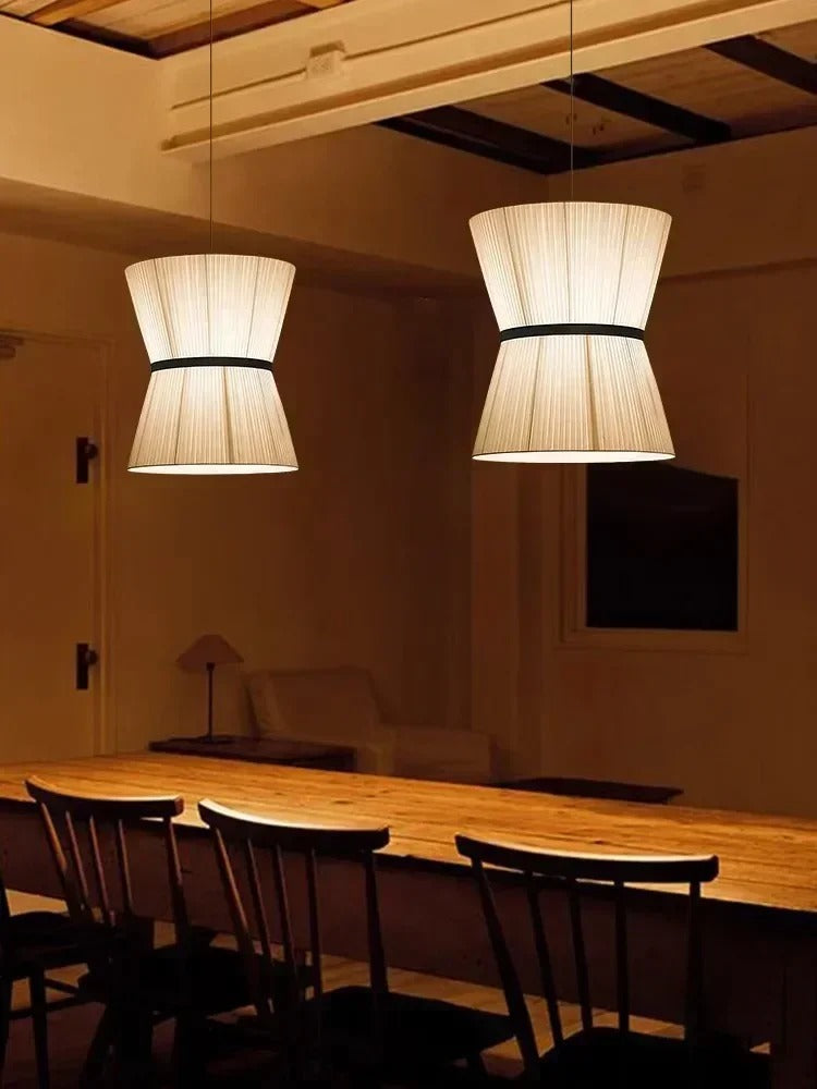 Knitted hourglass shades above a counter with stools