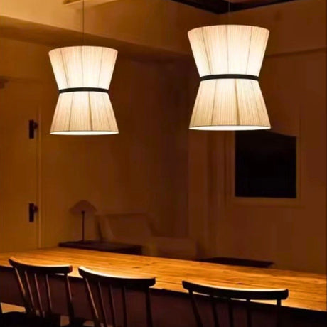 Row of knitted hourglass shades above a long dining table