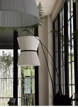 Knitted hourglass shade lit from inside in a dark room