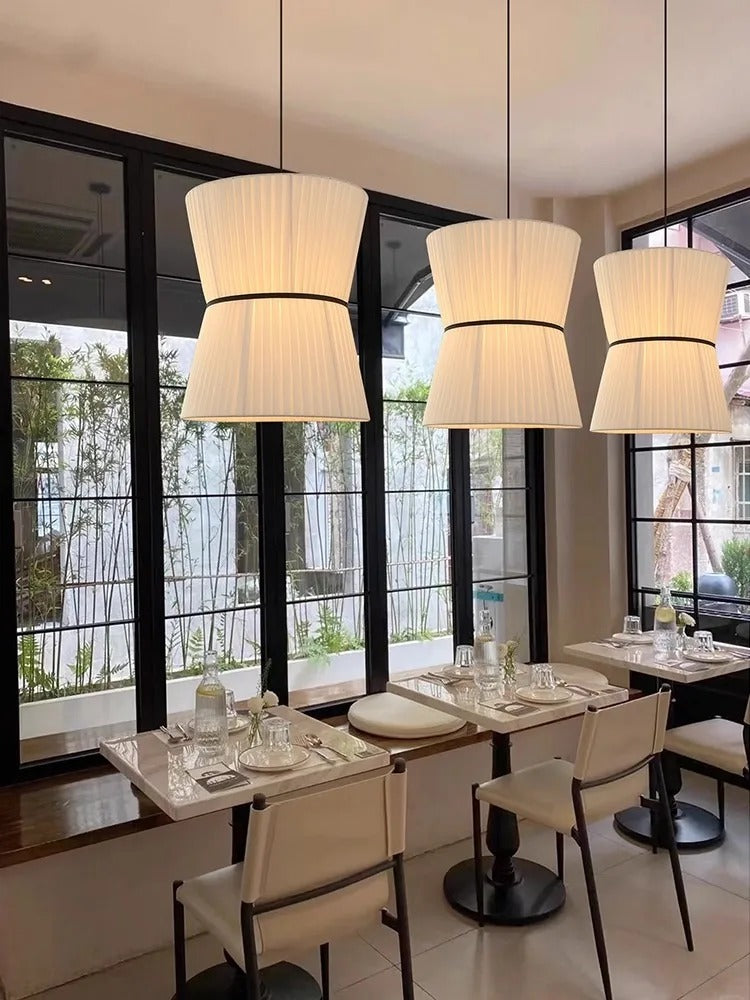 Knitted hourglass shades lit in a restaurant