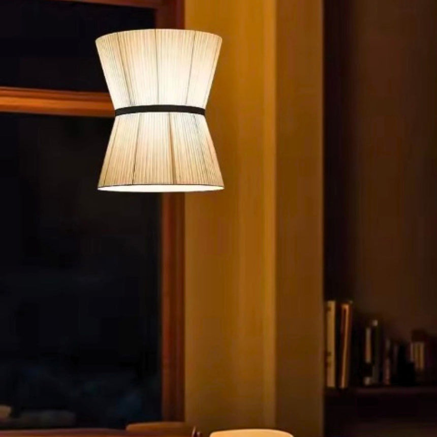 Knitted hourglass shades lit above a wooden table
