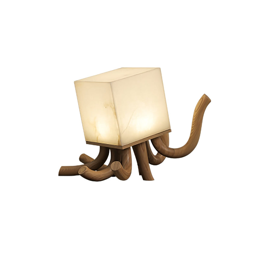 Sculptural table lamp in light wood, lit, against a plain ground