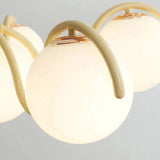 Close view of two opal globes held on the cream curved arms