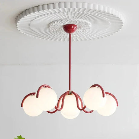 Red arms and six opal globes seen from below against a white ceiling