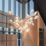 Close view of the glass shells lit against a wooden screen in an atrium