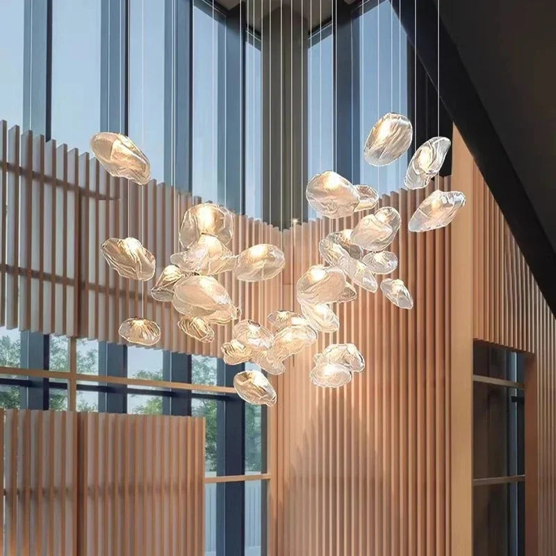 Close view of the glass shells lit against a wooden screen in an atrium