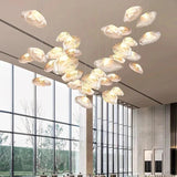Shells spread wide under a high ceiling beside a floor to ceiling window
