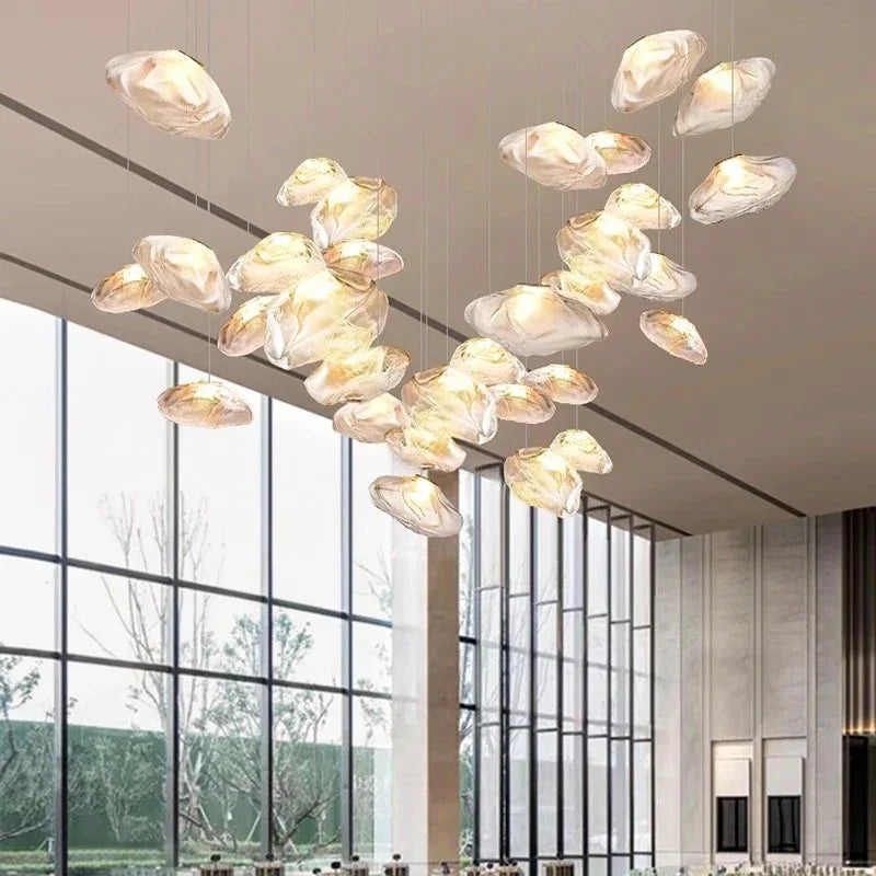 Shells spread wide under a high ceiling beside a floor to ceiling window