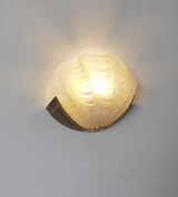 The translucent glass shade lit warm, the scallop edge glowing