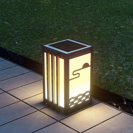 The lantern lit on dark paving showing the arc cut into the top panel