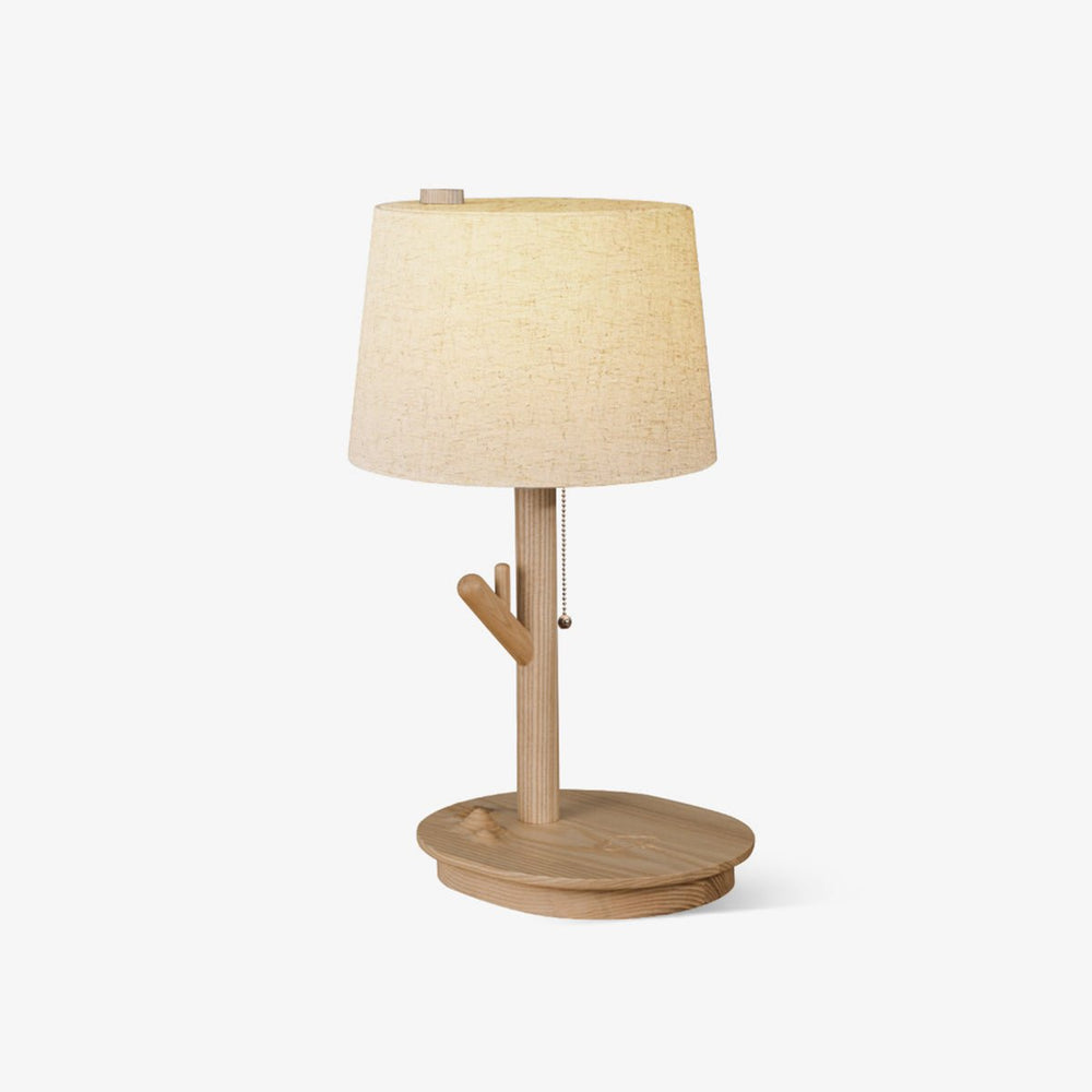Side table lamp with a branch stem on a shallow wood tray, shade unlit