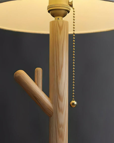 Close view of the branch stem with a beaded pull chain under the shade