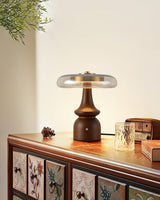 Side table lamp lit on a painted sideboard beside a small box