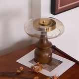 Side table lamp seen from above on a desk, the glass ring in view
