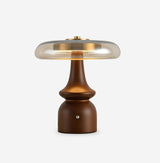 Side table lamp unlit against a pale ground, the wood grain visible