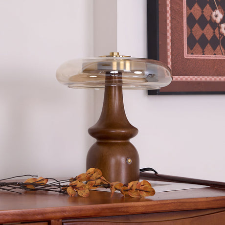 Side table lamp lit on a desk with dried branches across the front