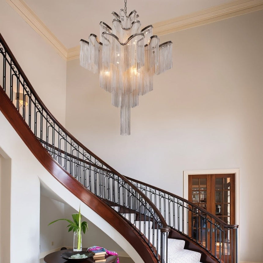 The silver version hanging in a tall hall above a curved staircase and its railing