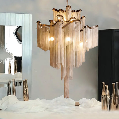 The gold version lit in a pale room beside a round mirror and tall floor vases