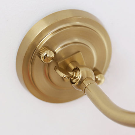Close view of the round stepped plate where the curved arm meets the wall