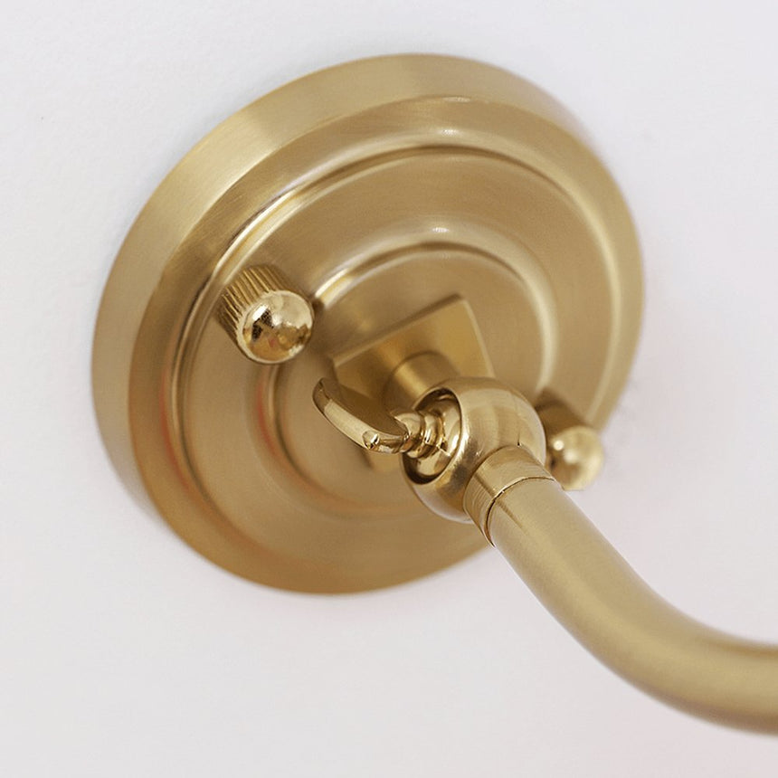 Close view of the round stepped plate where the curved arm meets the wall