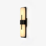 The veining in the panel picked out by the light along the sconce