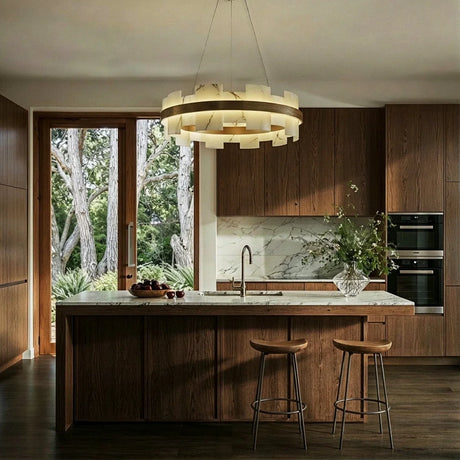 A lit stone ring above a kitchen island beside a garden door