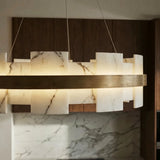 A lit stone ring above a marble counter in a timber kitchen