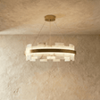 Stepped blocks of veined stone set around a lit brass ring