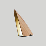 Small bedside lamp in natural wood lit and seen from the front