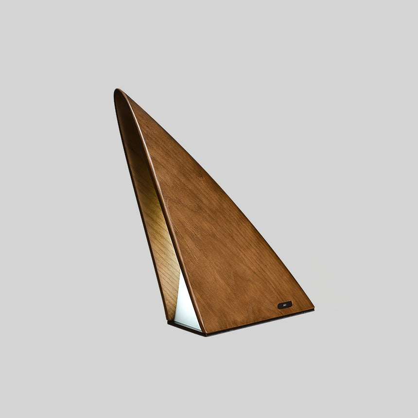 Small bedside lamp in natural wood unlit, the grain visible
