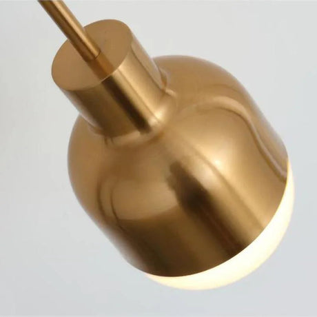 Close view of the rounded white glass tip under the brass body