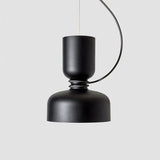 Black pendant with a cylinder above a bowl, seen against gray