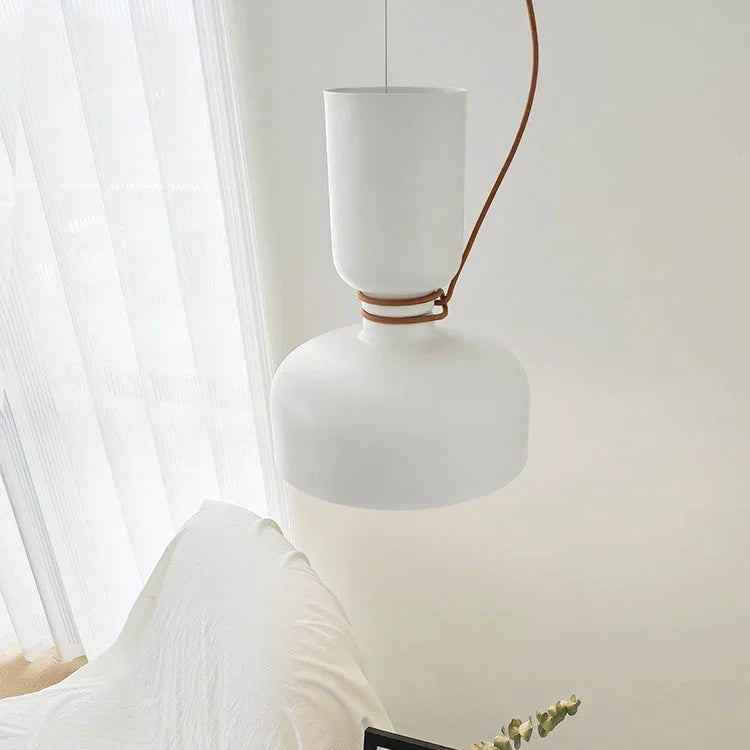Pale pendant hung against a white curtain