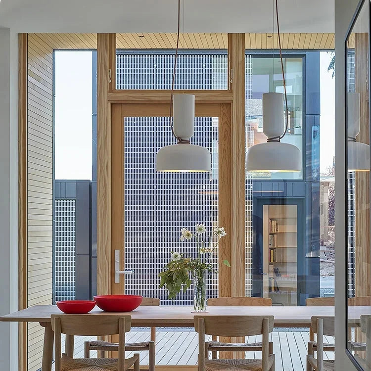Pendants above a dining table by a garden window
