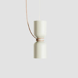 Cream pendant with a cylinder above a bowl, seen against gray