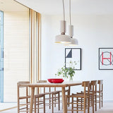 Two pendants above a table in a white kitchen