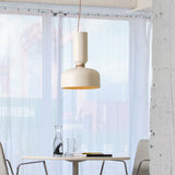 Pendant above a small table by a bright window